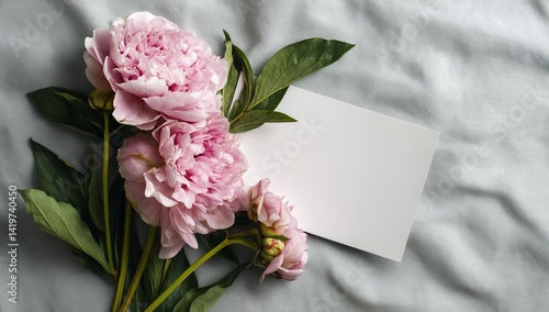 Fototapeta Naklejka Na Ścianę i Meble -  Elegant mockup of an empty blank square card with pink peonies and green leaves on the sides, top