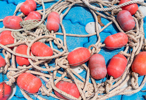 A fishing buoy with a rope attached to it for maritime safety, to demarcate areas at sea for coastal activities.