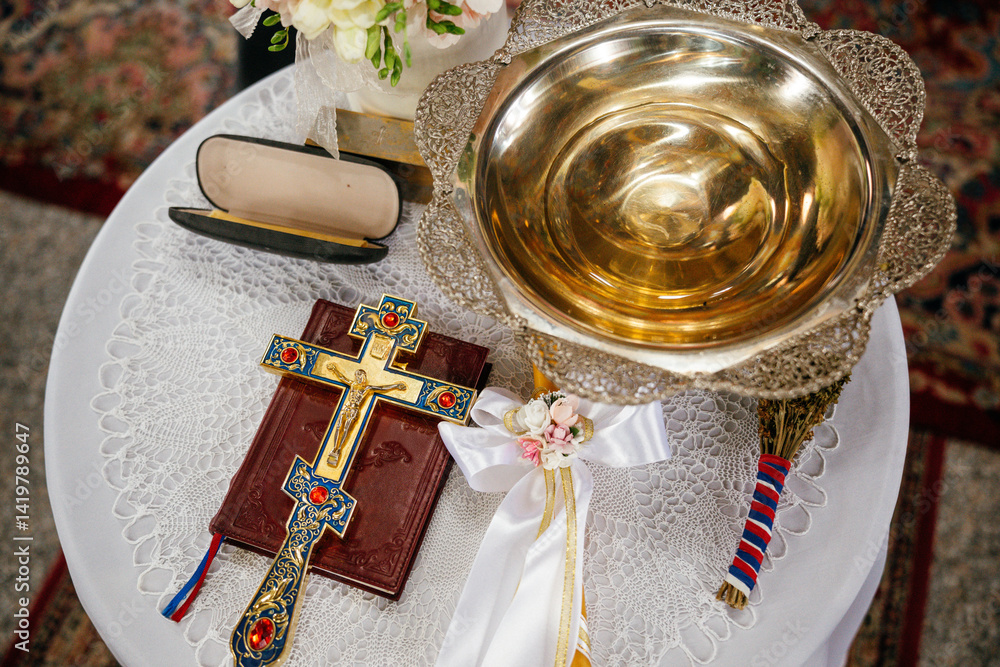 Novi Sad, Serbia - March 29, 2025: Accessories of a priest for Christian baptism. The text in the book is in Serbian
