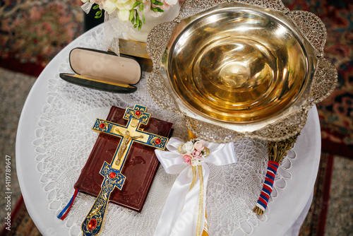 Obraz na płótnie Novi Sad, Serbia - March 29, 2025: Accessories of a priest for Christian baptism. The text in the book is in Serbian w salonie