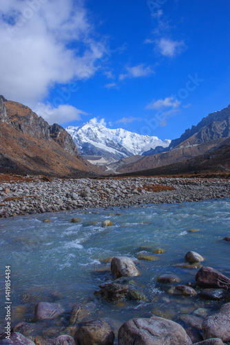 A beautiful stream and a snow capped Himalayan peak - photographed during trekking in the Goecha La route in Sikkim (India)