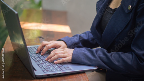 Wallpaper Mural Close-up of businesswoman's hand typing something on laptop in bright atmosphere and empty space for text. Torontodigital.ca