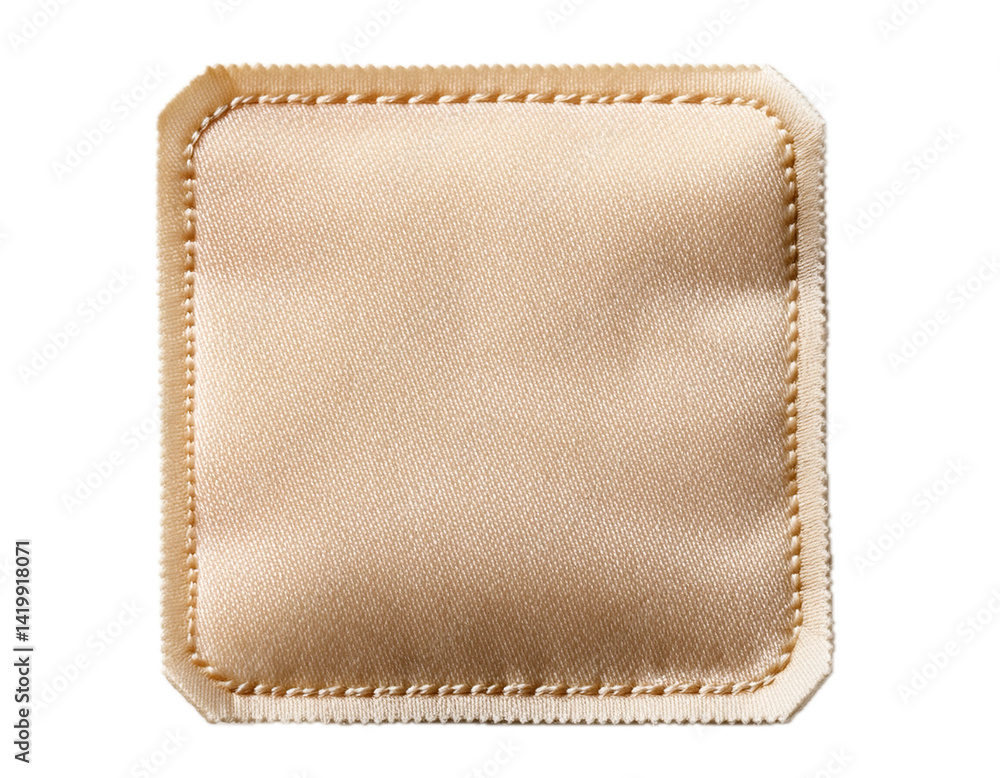 A close-up view of a blank off-white fabric label with a stitched border, isolated on a white background. A close-up view of a blank off-white fabric label with a stitched border, isolated on a white background.