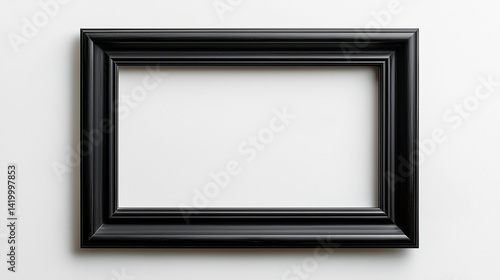 A mockup of an empty black frame on the wall, leaning against a white background with plants and shadows