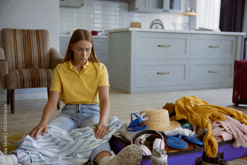 Unhappy woman tourist feeling worried because of clothing excess for travel