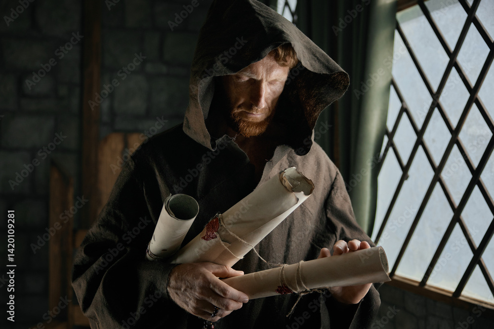 Medieval monk holding obsolete historical parchments and holy manuscripts