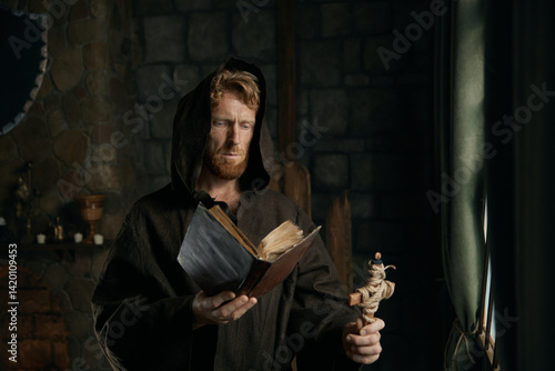 Obraz na płótnie Thoughtful medieval monk reading ancient book in cathedral w salonie