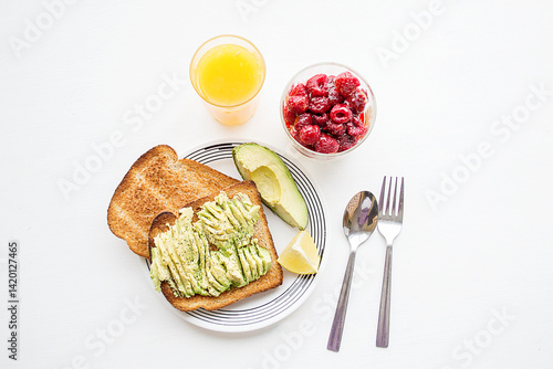 Breakfast with Avocado Toast, Raspberries and Fresh Orange juice