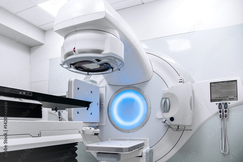 Empty radiotherapy treatment room with linear accelerator ready for use. The clean, modern medical environment showcases advanced cancer treatment technology and precision equipment for patient care Empty radiotherapy treatment room with linear accelerator ready for use. The clean, modern medical environment showcases advanced cancer treatment technology and precision equipment for patient care