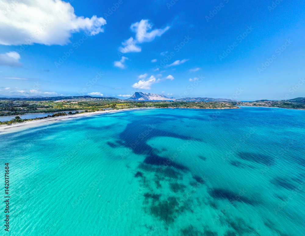 Drone view of Cala Brandinchi under a blue sky