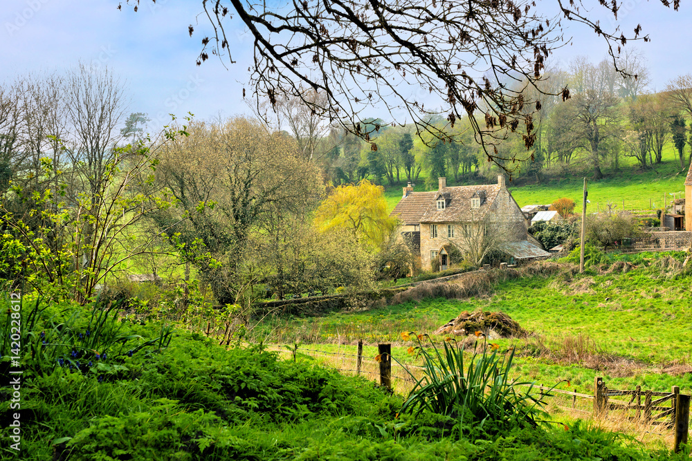 Quaint farmhouse in the beautiful countryside of the Cotswolds during spring, Gloucestershire, England, UK