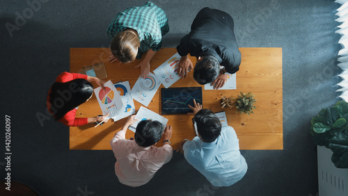 Obraz na płótnie Top down aerial view of smart business people analyze data together at meeting. Group of business team working together and looking at financial chart at tablet placed on meeting table. Convocation. w salonie