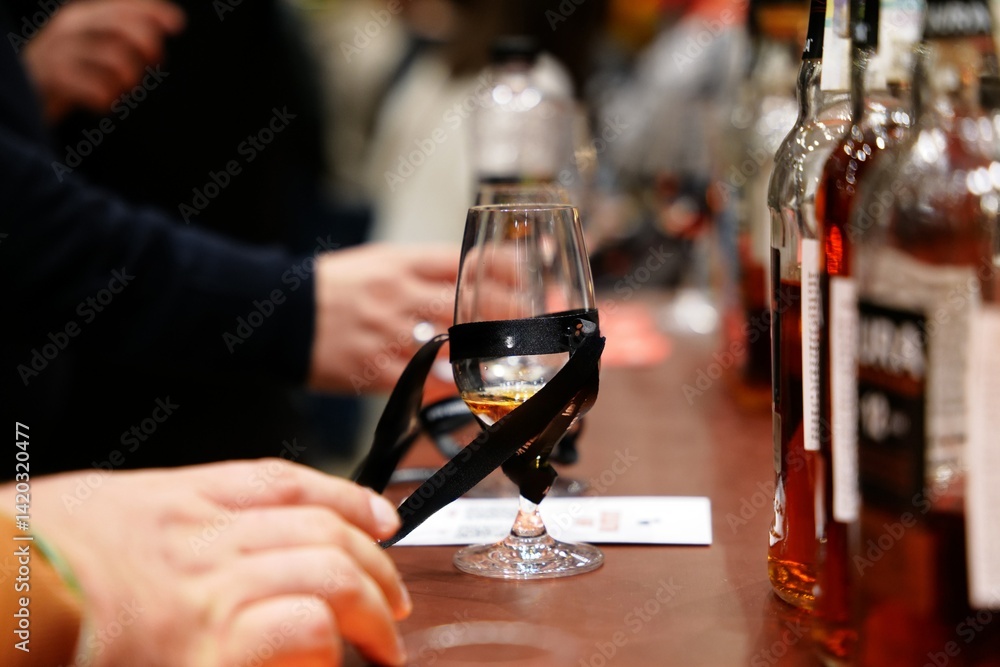 Tasting fine spirits at a local distillery event in the evening glow Tasting fine spirits at a local distillery event in the evening glow