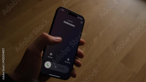 Fraud or fraudulent schemes. Close-up of a male hand holding a phone with an unexpected incoming call from an unknown