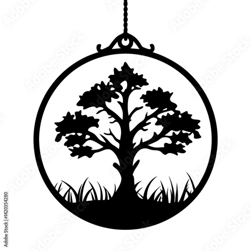 Silhouette of a tree in a circle ornament hanging from a thread