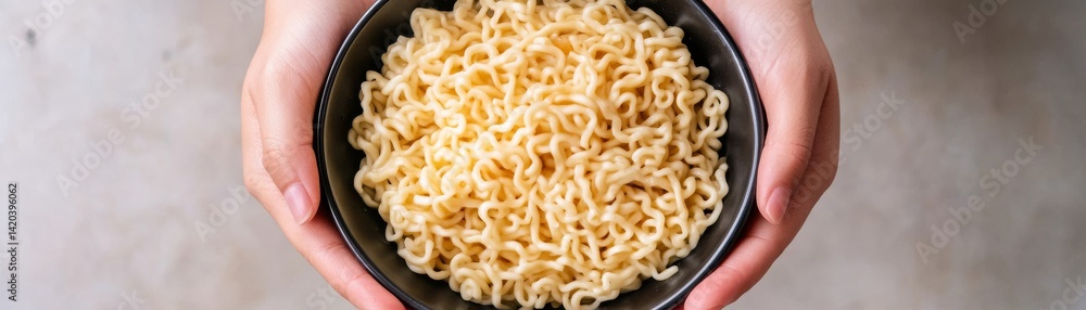 Hands Holding Black Bowl of Plain Noodles, Comfort Food , Simple Meal Hands Holding Black Bowl of Plain Noodles, Comfort Food , Simple Meal