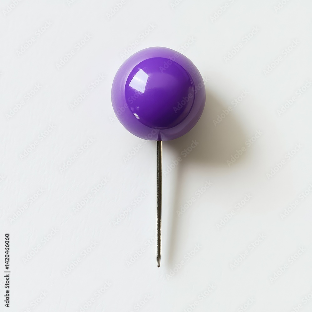 A single purple pushpin with a shadow on a white surface close up view A single purple pushpin with a shadow on a white surface close up view