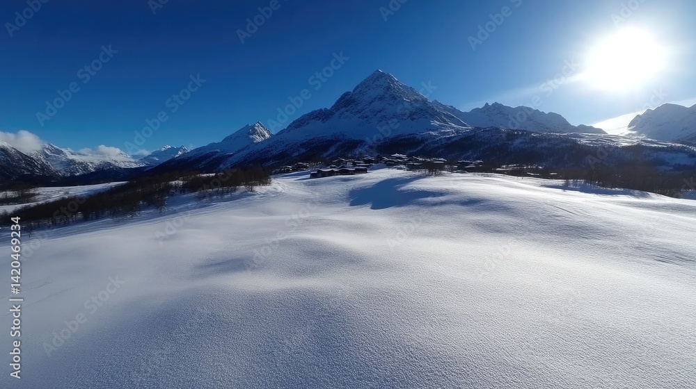 Pristine winter wonderland. Vast snowy expanse stretches before snow-capped mountains, a small village nestled below Pristine winter wonderland. Vast snowy expanse stretches before snow-capped mountains, a small village nestled below