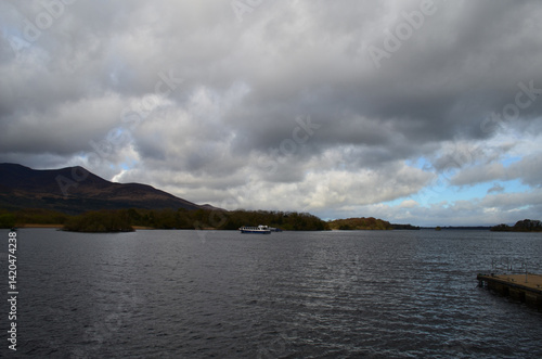 Dark Clouds and Mountains Over Body of Water