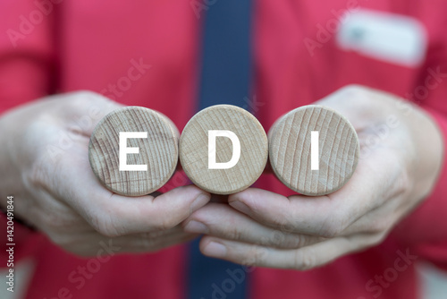 Business person holding wooden blocks with inscription: EDI. EDI or Electronic Data Interchange Concept.