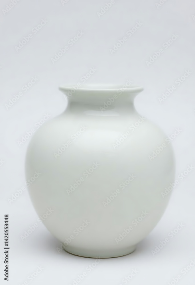white vase sitting on top of a white table white vase sitting on top of a white table
