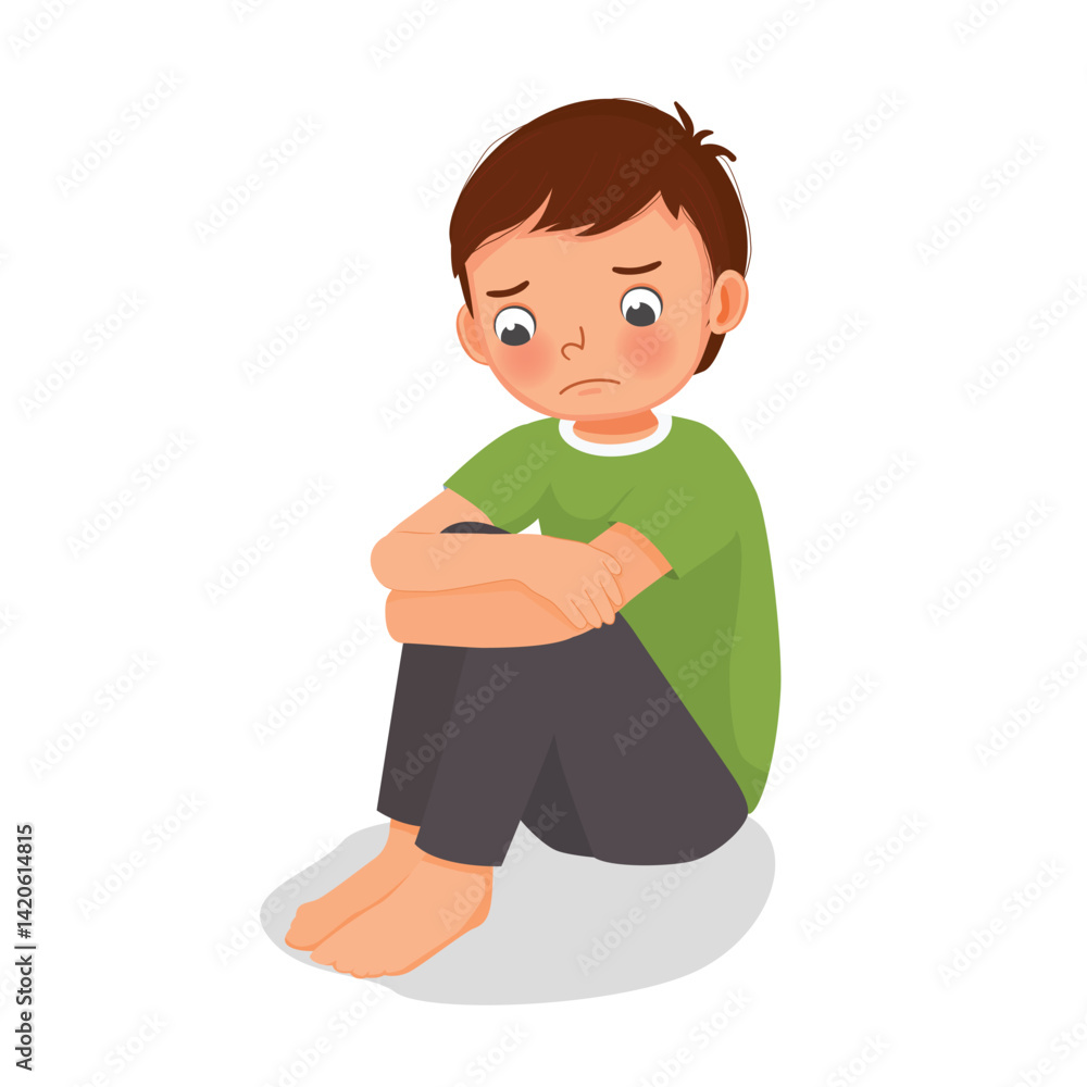 Sad little boy sitting with hands holding his knee
Sad little boy sitting with hands holding his knee