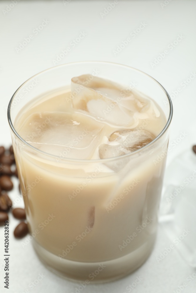 Coffee cream liqueur in glass and beans on white table, closeup Coffee cream liqueur in glass and beans on white table, closeup