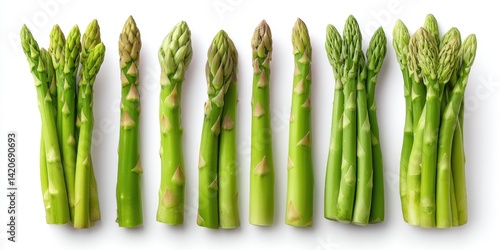 Close-up of fresh green asparagus spears arranged in a row on a clean white surface.