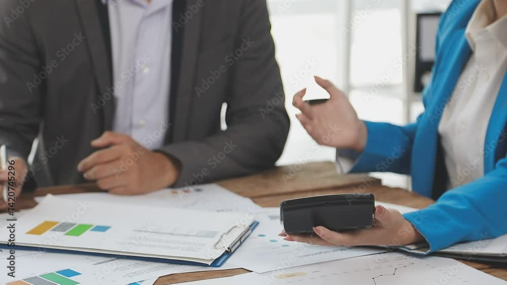 Financial analysts analyze business financial reports on a digital tablet planning investment project during a discussion at a meeting of corporate showing the results of their successful teamwork. Financial analysts analyze business financial reports on a digital tablet planning investment project during a discussion at a meeting of corporate showing the results of their successful teamwork.