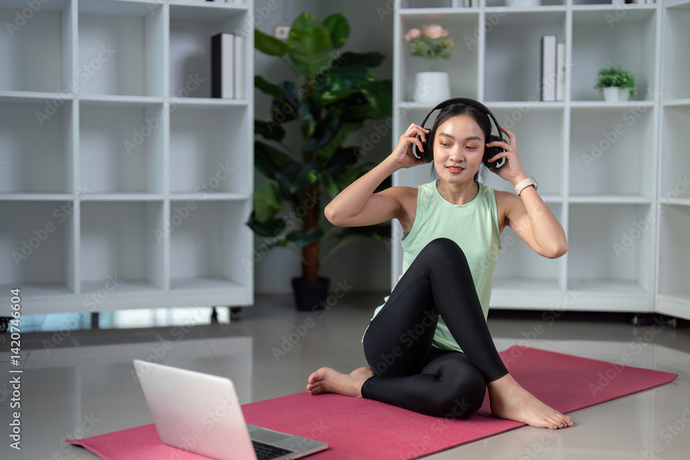 Wellness and Online Fitness. A fitness enthusiast immersing herself in a guided session through her laptop, enhancing personal wellness. Wellness and Online Fitness. A fitness enthusiast immersing herself in a guided session through her laptop, enhancing personal wellness.