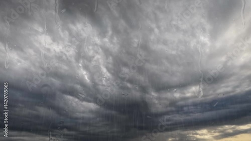 fast timelapse clip with massive rain and big cold leaden clouds