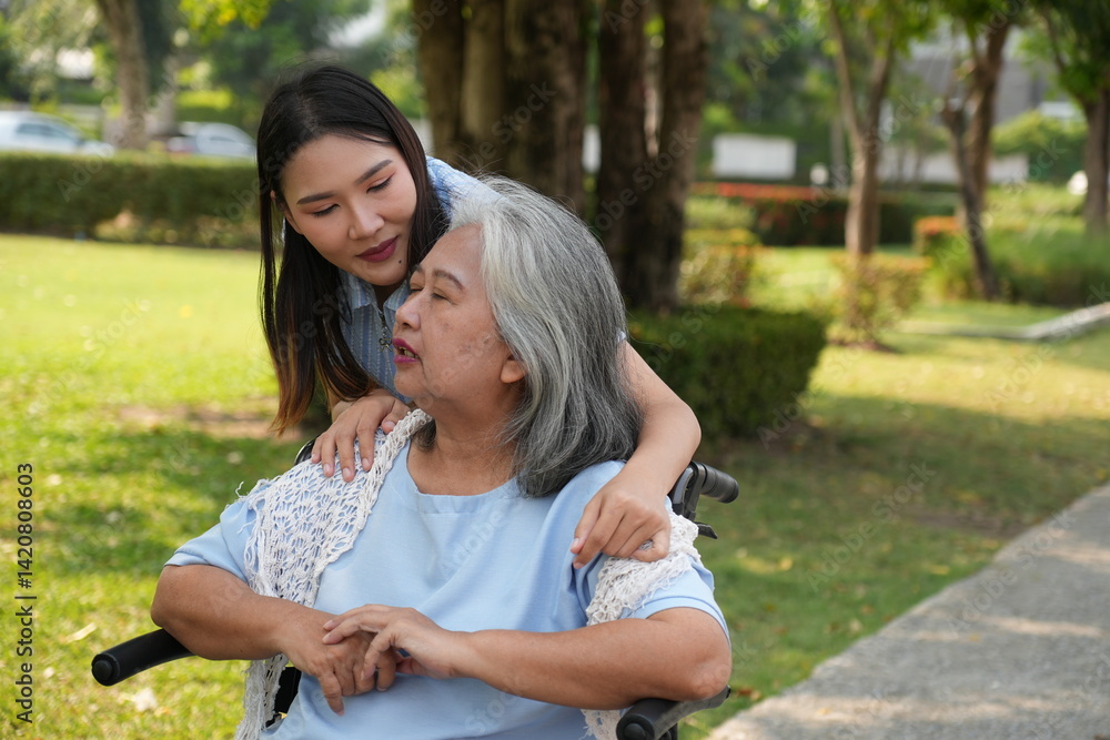 Two women, the daughter pushing a stroller with her elderly mother, walk in the garden and chat happily.