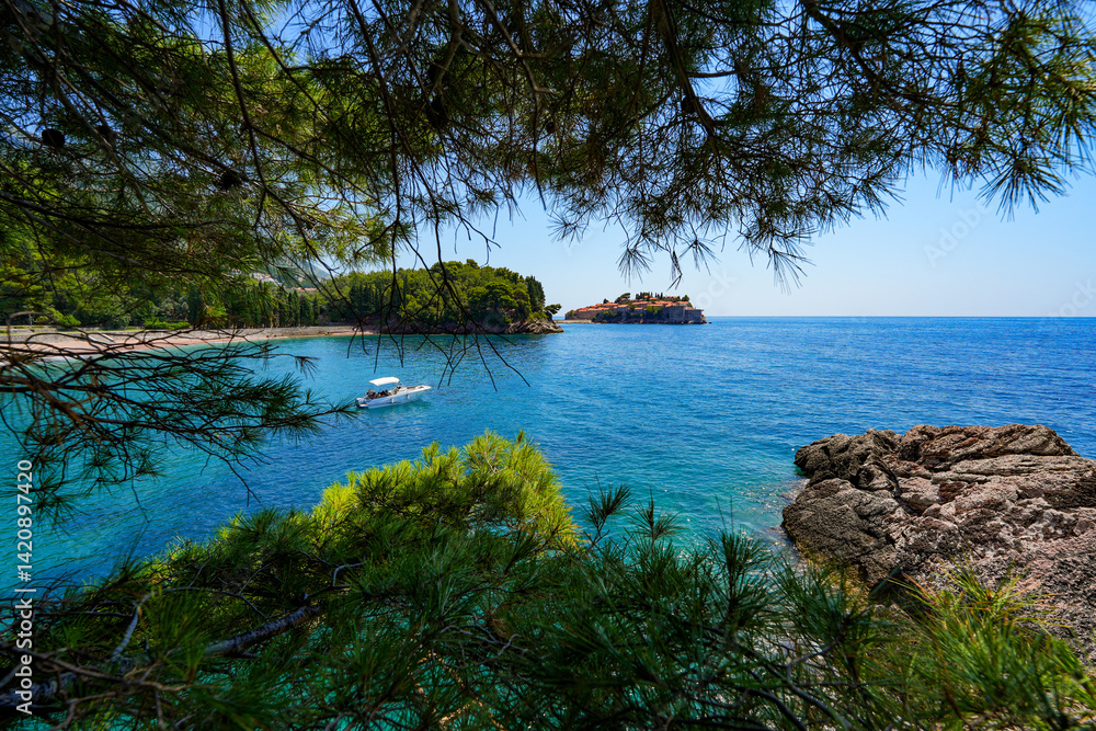 Sveti Stefan, a medieval village located on a small island connected to the mainland by a narrow tombolo (sandy isthmus) in the bay of Budva along the Adriatic Coast, Montenegro