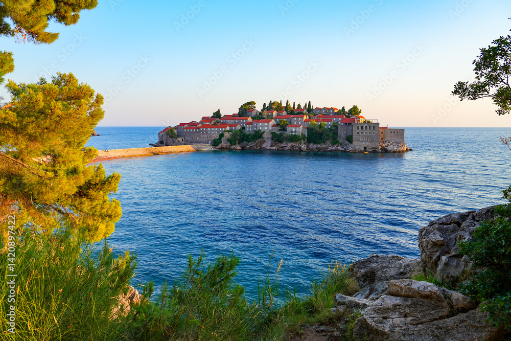 Sveti Stefan, a medieval village located on a small island connected to the mainland by a narrow tombolo (sandy isthmus) in the bay of Budva along the Adriatic Coast, Montenegro