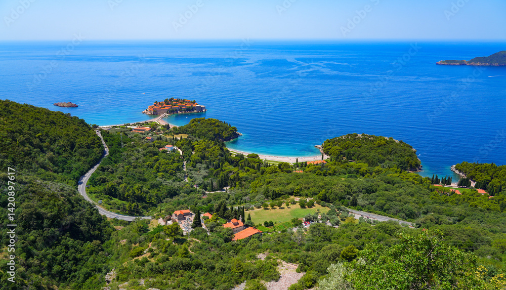 Aerial view of Sveti Stefan, a medieval village located on a small island connected to the mainland by a narrow tombolo (sandy isthmus) in the bay of Budva along the Adriatic Coast, Montenegro