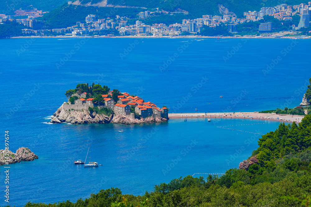 Sveti Stefan, a medieval village located on a small island connected to the mainland by a narrow tombolo (sandy isthmus) in the bay of Budva along the Adriatic Coast, Montenegro