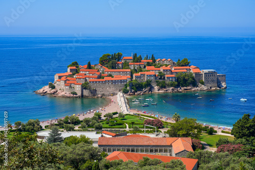 Obraz na płótnie Aerial view of Sveti Stefan, a medieval village located on a small island connected to the mainland by a narrow tombolo (sandy isthmus) in the bay of Budva along the Adriatic Coast, Montenegro w salonie