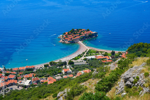 Obraz na płótnie Aerial view of Sveti Stefan, a medieval village located on a small island connected to the mainland by a narrow tombolo (sandy isthmus) in the bay of Budva along the Adriatic Coast, Montenegro w salonie