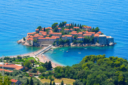 Obraz na płótnie Aerial view of Sveti Stefan, a medieval village located on a small island connected to the mainland by a narrow tombolo (sandy isthmus) in the bay of Budva along the Adriatic Coast, Montenegro w salonie