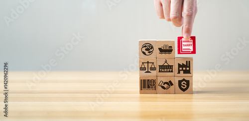 Obraz na płótnie Tariff and international trade concept with wooden blocks showing import, export, shipping, factory, agreement, and tax symbols