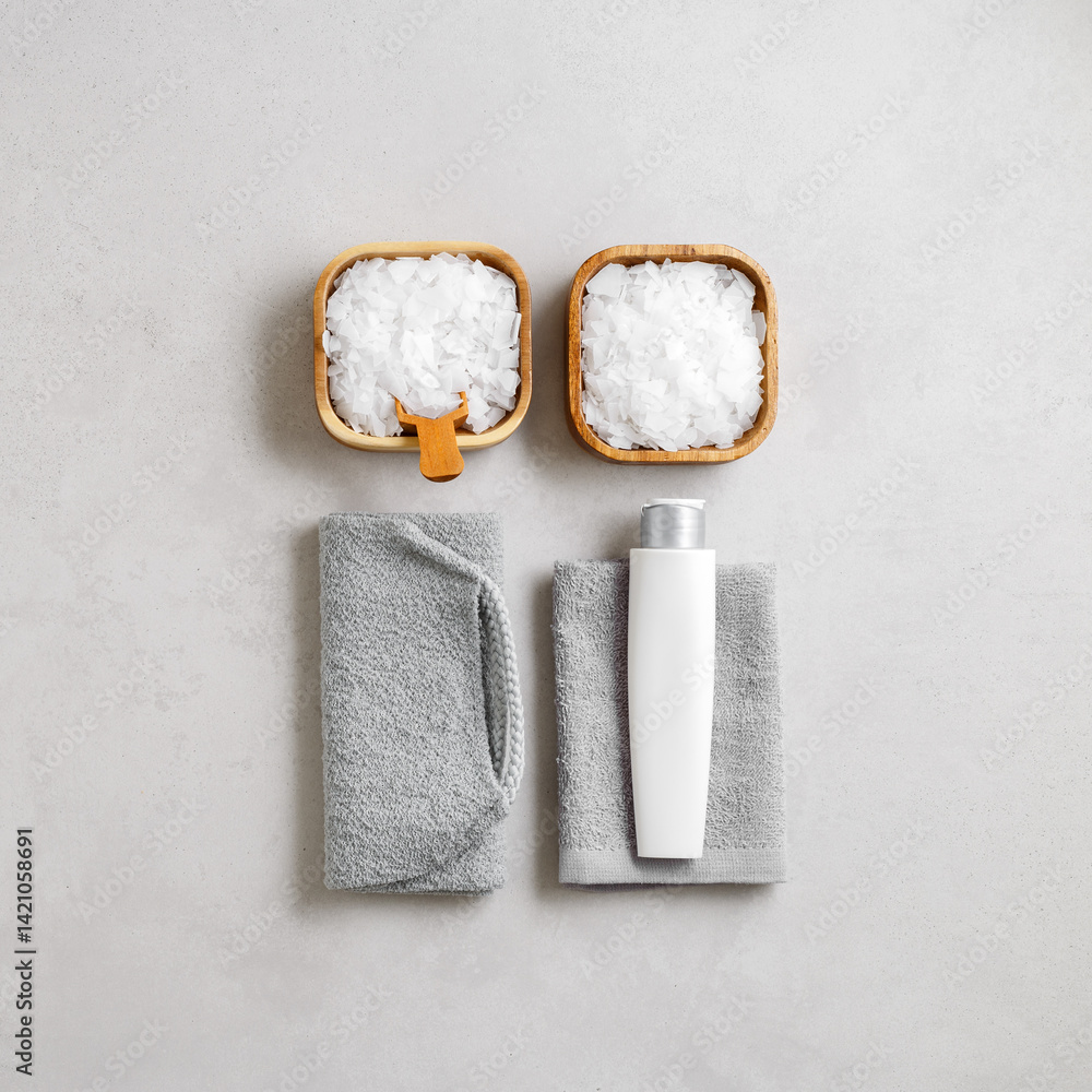 Spa, wellness, bath products as minimal style aesthetic pattern, magnesium salt flakes, folded grey towels, natural brushes, massagers, reusable pads, gray background, top view lifestyle content