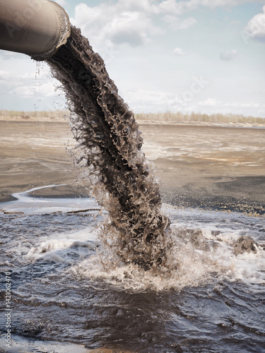 Dirty sewage pollutes the environment. Powerful waste stream from the pipe.