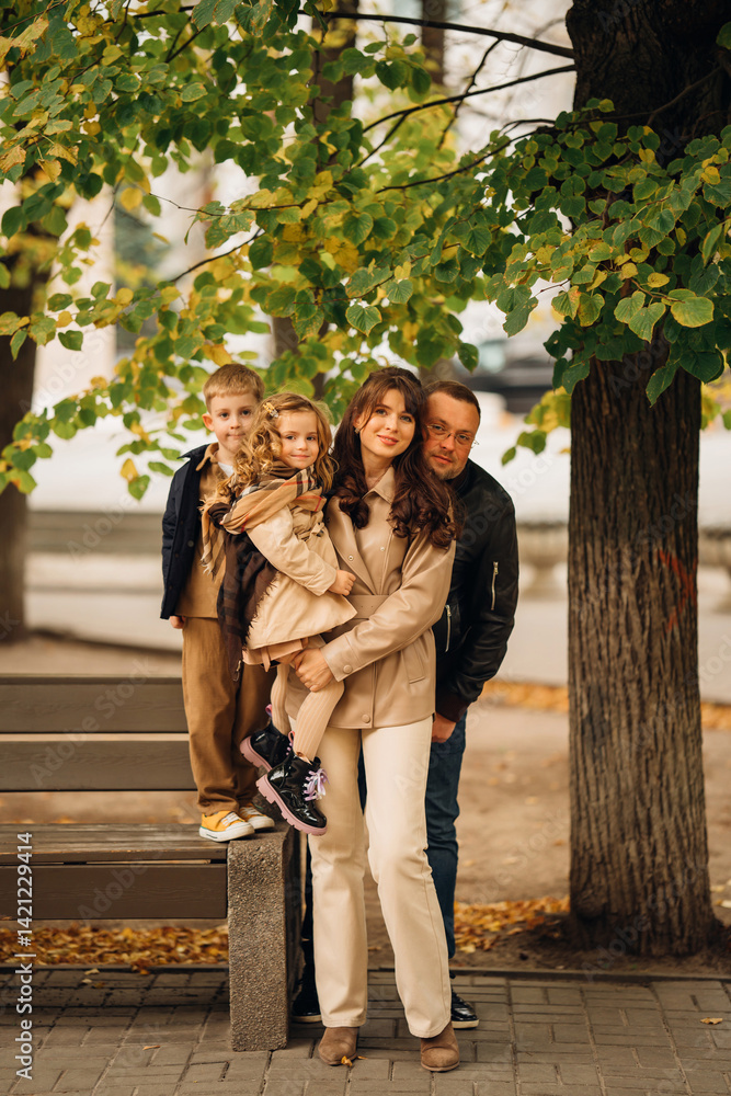 Family enjoying a joyful moment in a park during autumn