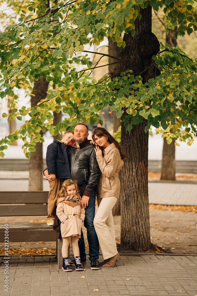 Family enjoying a joyful moment in a park during autumn