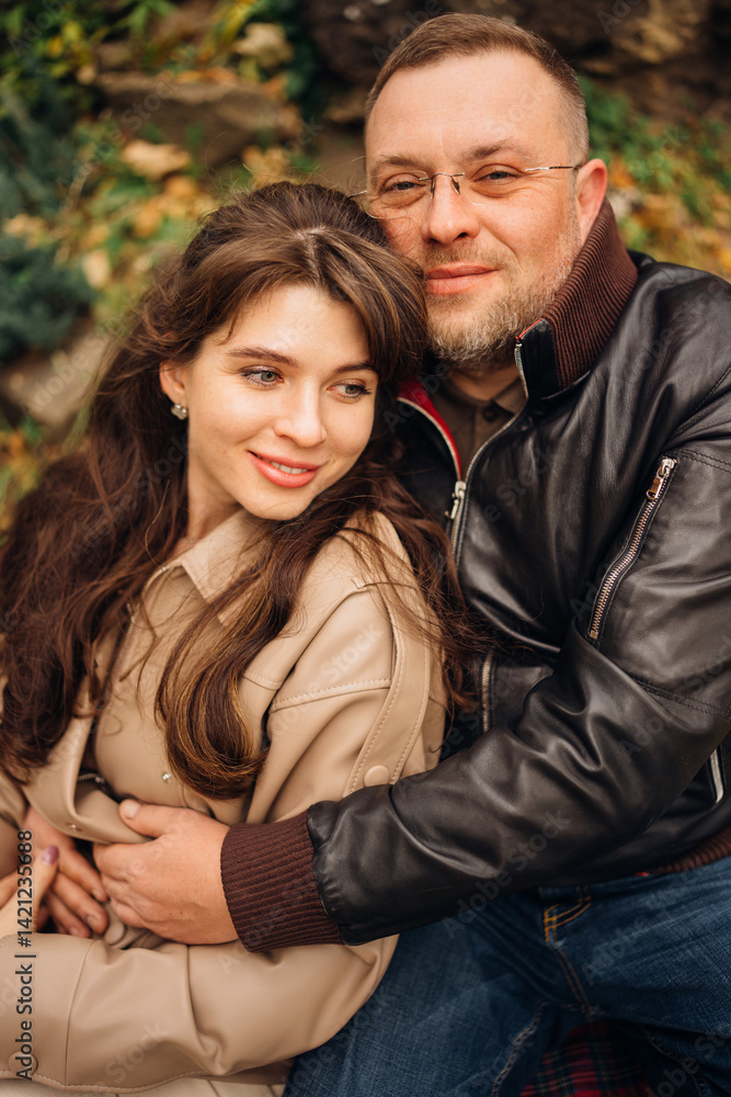 Couple enjoying a cozy moment outdoors during autumn season