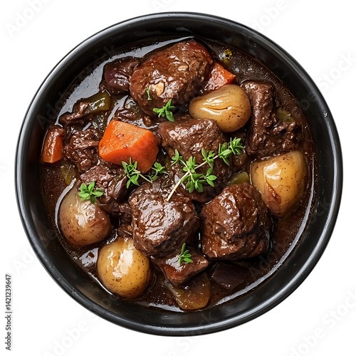 A serving of Boeuf Bourguignon with beef chunks potatoes carrots onions and herbs in a rich sauce inside a dark bowl photographed from top on a transparent background