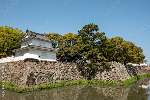 Traditional Japanese castle wall and turret by a moat in Oita, Japan