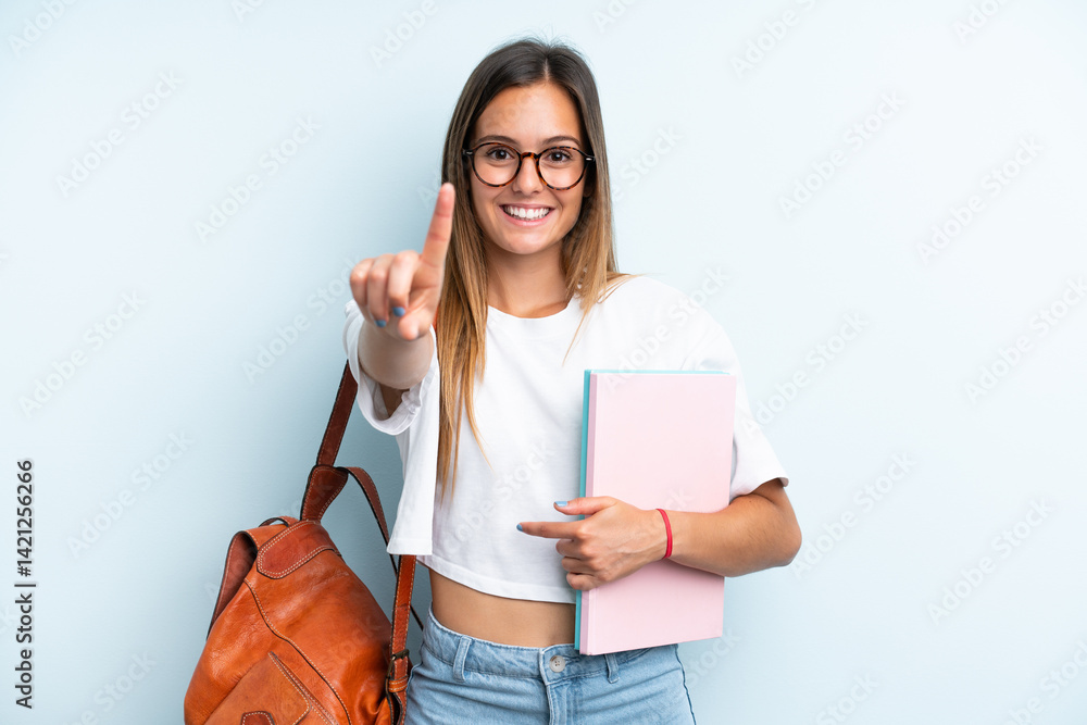Young student woman isolated on blue background showing and lifting a finger Young student woman isolated on blue background showing and lifting a finger