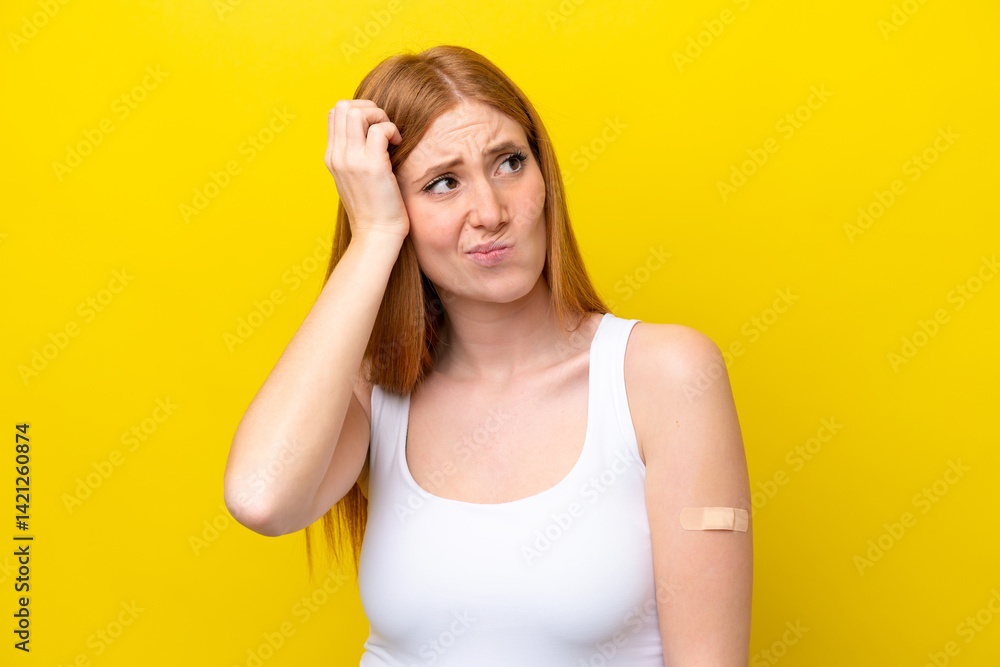 Young redhead woman wearing a band-aids isolated on yellow background having doubts and with confuse face expression Young redhead woman wearing a band-aids isolated on yellow background having doubts and with confuse face expression