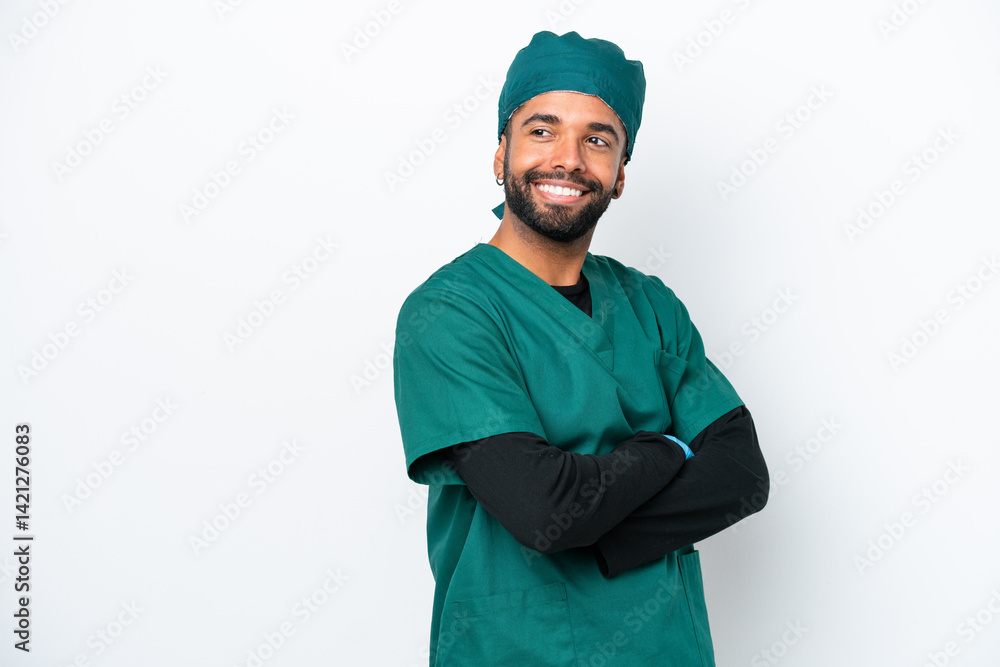 Surgeon Brazilian man in green uniform isolated on white background with arms crossed and happy Surgeon Brazilian man in green uniform isolated on white background with arms crossed and happy